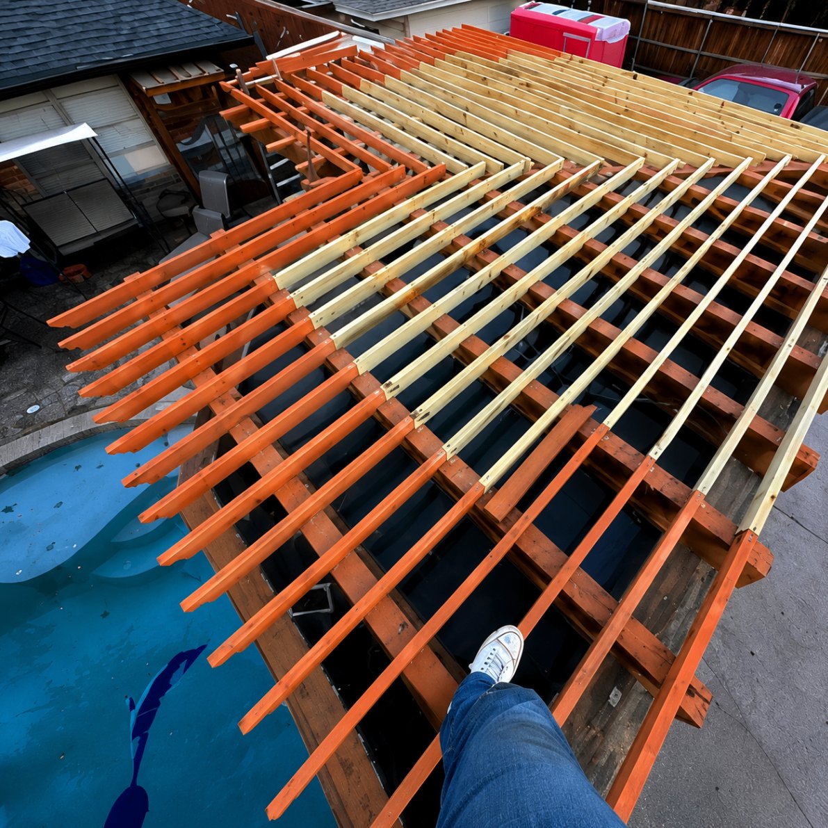 Custom patio cover framing — cedar rafters over an existing pool deck in Plano.